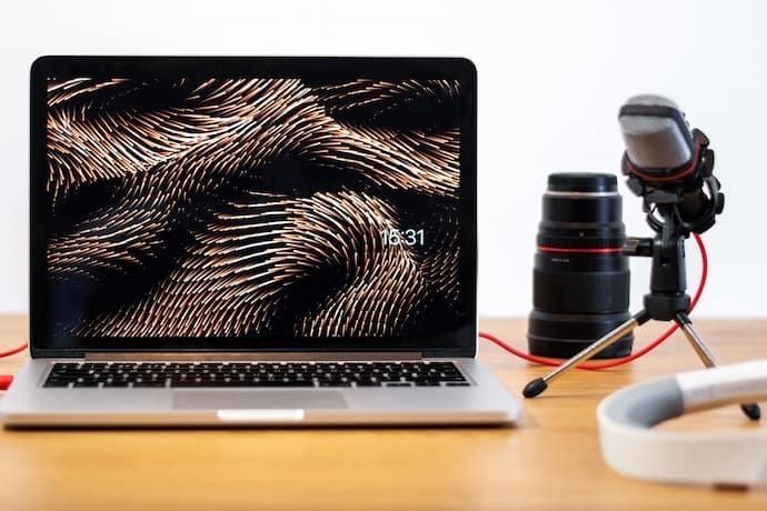 Notebook para edição de vídeo com microfone e lente de câmera ao lado